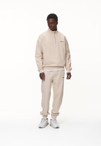 Pegador LOGO JOGGER - Tréningruha alsók - washed desert sand/black gum