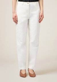 Witte katoenen broek met bloemembroiderie op de linkerdij. De broek heeft een rechte pijpdesign en een knoopsluiting bij de taille.