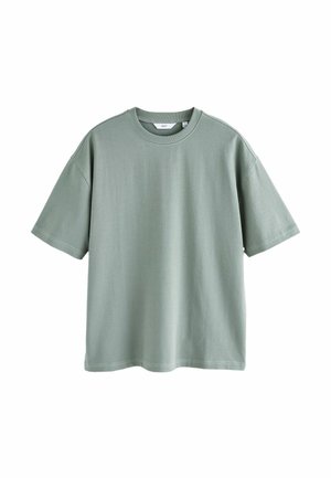 T-shirt verde chiaro a maniche corte in cotone, con scollatura rotonda e vestibilità comoda, arricchita da dettagli di cucitura in vista.