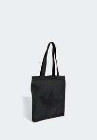 Černá síťovaná taška přes rameno s dvojitými uchy, s texturovaným povrchem a velkým vzorem loga v kontrastní barvě. Kompaktní čtvercový tvar.