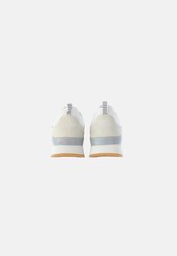 Scarpe sportive bianche con tomaia in mesh traspirante, dettagli grigi, suola ammortizzata e suola in gomma beige, dotate di un linguetta posteriore per facilitare l'indossamento.