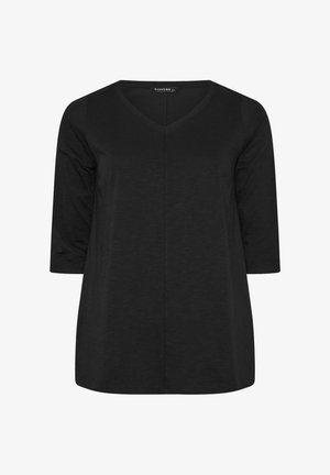 Musta V-kaula-aukollinen paita, jossa on kolme neljänneshihaa ja rento istuvuus. Edessä keskellä saumalinja.