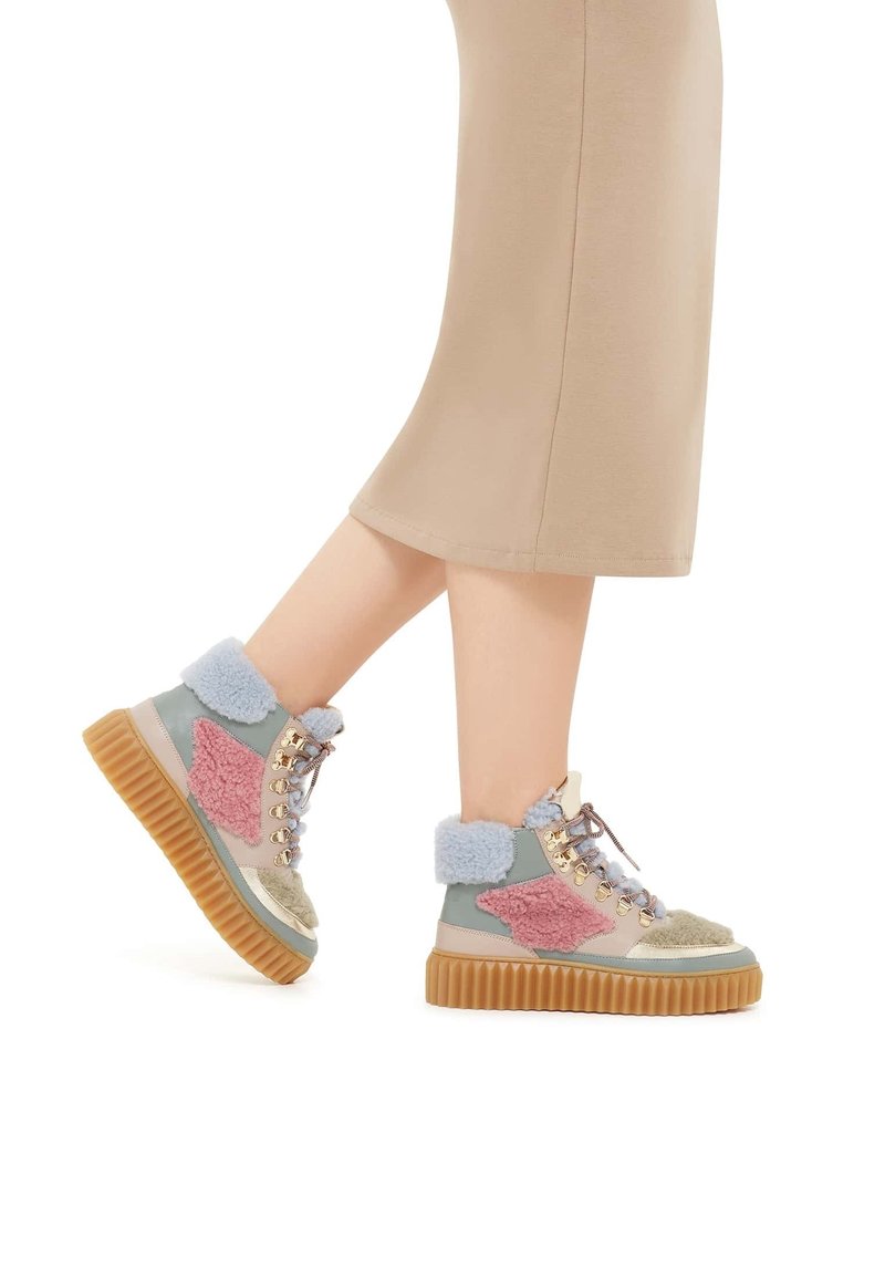 Stivaletti multicolore alla caviglia con pannelli testurizzati in rosa, verde e blu, colletto in pelliccia sintetica beige e suola in gomma spessa.