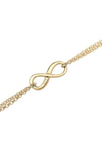 Guld kædearmbånd med et uendelighedssymbol vedhæng. Vedhænget er poleret med en glat overflade, og kæden har et delikat design.