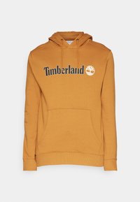 Sudadera con capucha naranja de algodón, que presenta un bolsillo frontal, puños de canalé y el logo de "Timberland" con un icono de árbol en blanco.