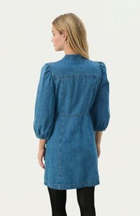 Denim dress with puff sleeves, a fitted waist, and a front button closure. Blue fabric with a smooth texture; knee-length design.