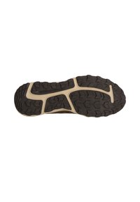 Sort gummi ydersål med robust mønster, der har en beige mellemsål. Ordet "UDDHOLDENHED" er prægede på overfladen.