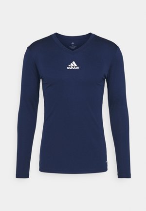 Navy langärmliges Sporthemd aus strukturiertem Stoff mit V-Ausschnitt und weißem Adidas-Logo auf der Brust. Schlichtes Design, taillierte Form.
