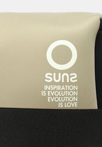 Tessuto beige e nero con un logo circolare bianco sopra il testo capovolto "suns" e la frase "L'ispirazione è evoluzione, l'evoluzione è amore."