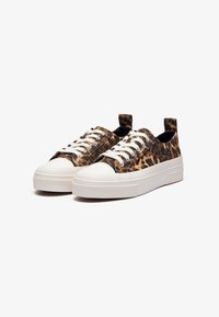 Leopard print canvas sneakers with white rubber soles, textured finish, and lace-up front. Features a pull tab at the heel for easy wear.