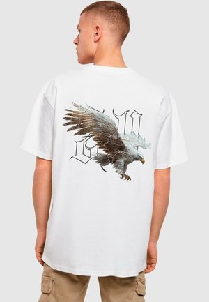 White cotton t-shirt featuring a large printed design of an eagle with detailed wings on the back, complemented by stylized black lettering.