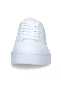 White sneaker with smooth synthetic upper, round toe, lace-up front, and a thick, flat rubber sole. Features subtle brand logo on the tongue.