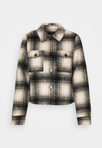 Czarna i biała kurtka w kratę z kołnierzem, dwoma kieszeniami na piersi z patkami oraz zapięciem na guziki z przodu. Miękka, teksturowana tkanina.