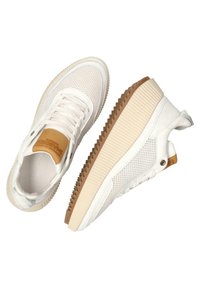 Białe sneakersy z siateczkowym i syntetycznym cholewką, beżową gumową podeszwą, teksturowanymi akcentami bocznymi oraz tradycyjnym systemem sznurowania.