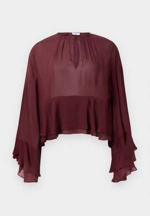 Burgundy chiffon blouse with a relaxed fit, round neckline, and long, flared sleeves featuring ruffled edges.