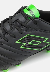 Lotto STADIO - Jalkapallokengät kiinteälle alustalle - all black/spring green