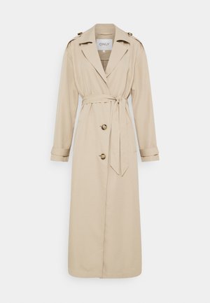 Beige trenchcoat med bälte i midjan, långa ärmar och dubbelknäppning framtill. Har axelklaffar på axlarna och rak fåll.