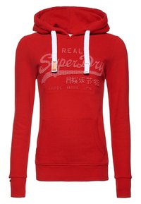 Rode capuchontrui met witte koordjes, zak aan de voorkant en grijze bedrukte tekst. Gemaakt van zachte stof met geribde boorden aan mouwen en zoom.