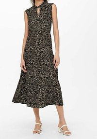 Svart och beige leopardtryck midiklänning med knytkrage, ärmlös design och utställd nederkant. Har en mjuk tygstruktur.