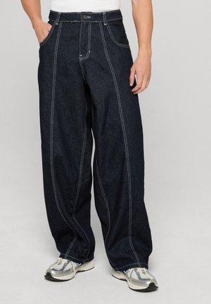 Dark denim wide-leg jeans feature contrasting white stitching, front pockets, and a button closure, presenting a relaxed silhouette.