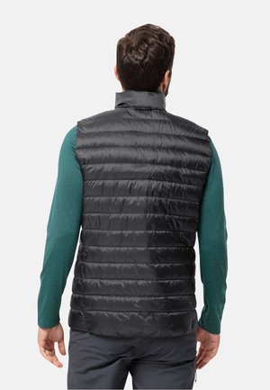 Black puffer vest with quilted design and high collar, worn over a green long-sleeve shirt, featuring a smooth, shiny texture.