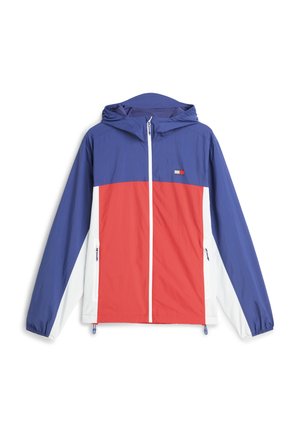 Veste à capuche zippée bleu, rouge et blanc avec poignets élastiques, poches avant et petit logo rectangulaire sur la poitrine.