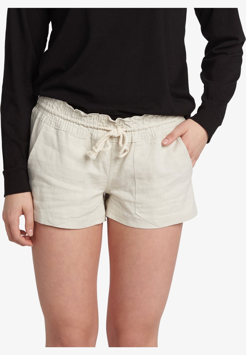 Linen shorts in light beige with an elastic waistband and drawstring. Features two side pockets and a relaxed, casual cut.