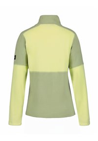 Chaqueta de forro polar verde claro con cuello alto, que presenta un diseño de bloques de color en amarillo suave y verde, fabricada con un tejido texturizado. Detalle del logo en negro en la manga.