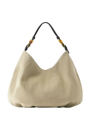 Beige soft fabric hobo bag with a black handle featuring amber and olive-colored decorative beads.