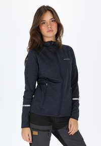 Navy blue, zip-up jacket made of textured fabric with two front pockets, reflective accents on sleeves, and a stand collar design.