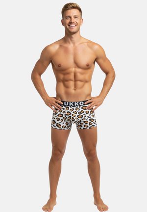 Boxer-briefs pour homme en tissu blanc avec un motif imprimé animal en noir et orange. Ceinture élastique avec texte du logo.