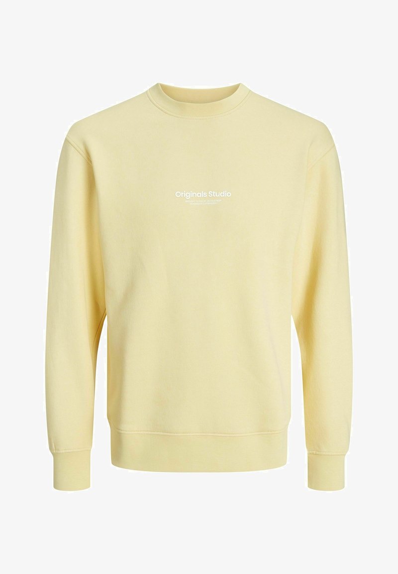 Light yellow long-sleeve crewneck sweatshirt with white "Originals Studio" text printed on the chest.