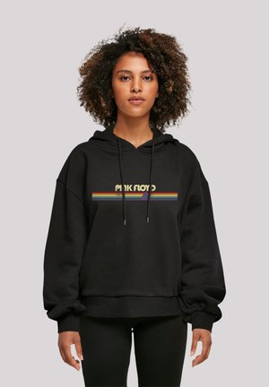 Black hoodie featuring a rainbow-striped "Pink Floyd" graphic across the chest. Made of soft fabric with a relaxed fit and drawstring hood.