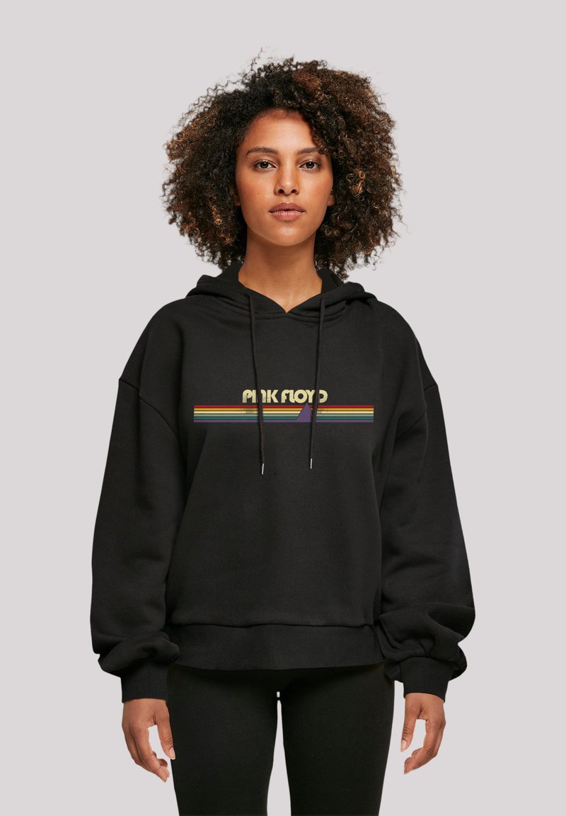 Black hoodie featuring a rainbow-striped "Pink Floyd" graphic across the chest. Made of soft fabric with a relaxed fit and drawstring hood.