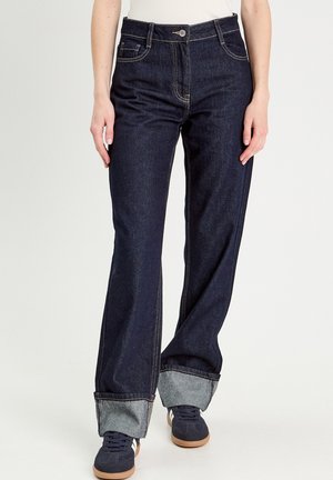 Dunkelblaue weit geschnittene Jeans mit einem hochgerollten hellblauen Saum. Verfügt über einen Reißverschluss, einen Knopfverschluss und fünf Taschen. Hergestellt aus Denim-Stoff.