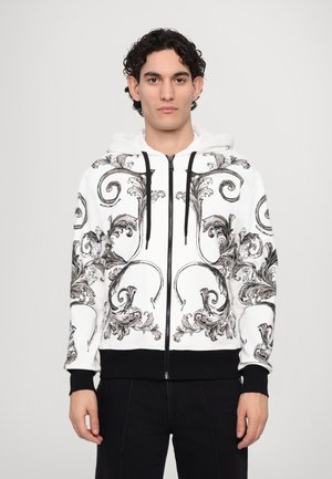 Hooded sweatshirt, white with black and gray ornate swirl pattern. Features a front zip, ribbed cuffs, and waistband. Simplistic design.