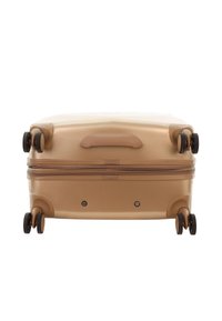 Hard-shell suitcase in beige with a textured finish, dual spinner wheels, a top handle, and a zipper closure along the front.