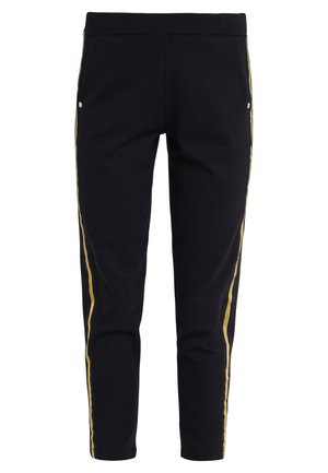 Black tapered pants with elastic waistband and gold side stripes, featuring small white snap closures near pockets.