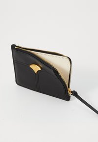Black leather wallet with gold zipper partially open, gold decorative clasp, and cream fabric interior on a white background.