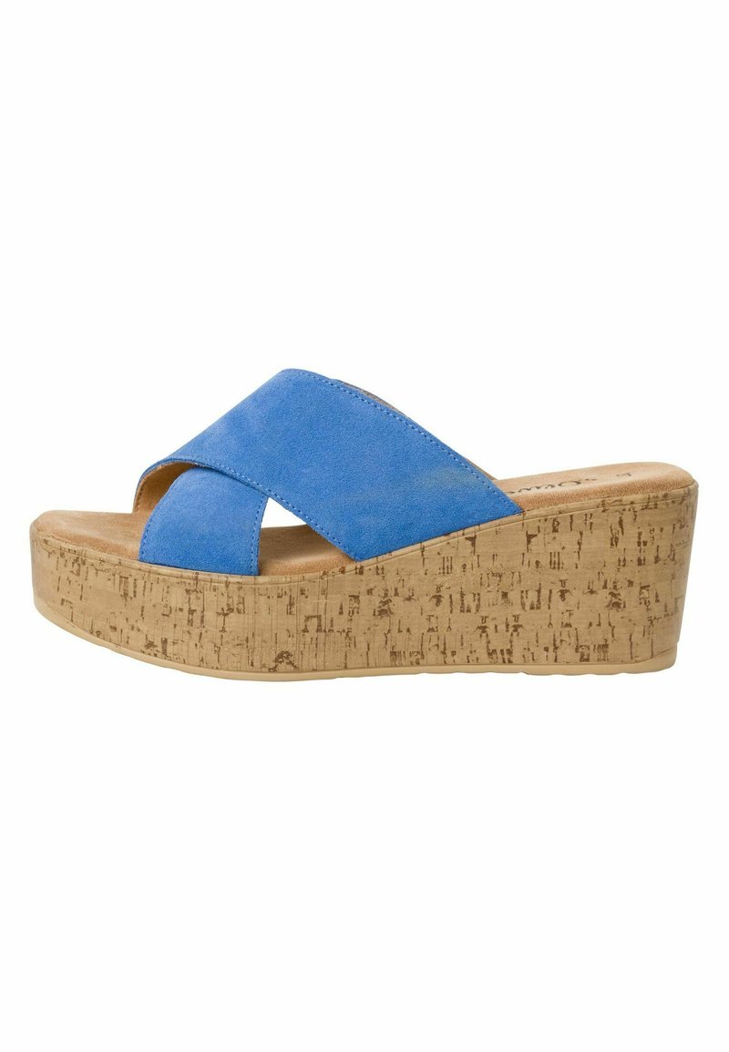 Sandales à plateforme en liège avec des brides croisées en daim bleu, offrant un ajustement sécurisé et une surface texturée sur la semelle.