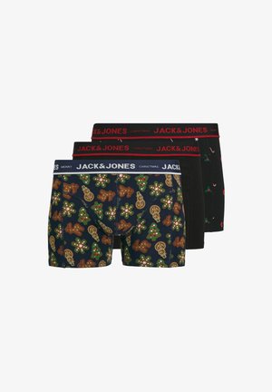 Trois paires de boxers pour hommes : une avec un fond bleu marine et des motifs de pain d'épice et d'arbre sur le thème des vacances, et deux noirs unis avec des accents rouges.