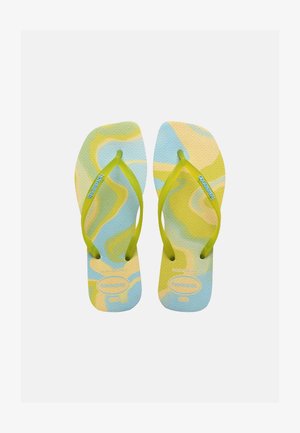 Pair of flip-flops with yellow-green straps and blue, yellow, and green wavy patterns on textured soles.