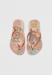 Copper-tone thong flip-flops with a patterned footbed featuring floral and graphic designs in pastel colors. Textured soles for grip.