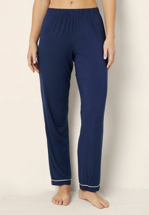 Pantalons de pyjama bleu marine en tissu doux, dotés d'une taille élastique et de passepoils blancs aux poignets pour une touche de détail.