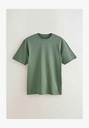 T-shirt in cotone verde con scollo rotondo, maniche corte e una superficie liscia. Nessun motivo o accento visibile. Orlo dritto standard.