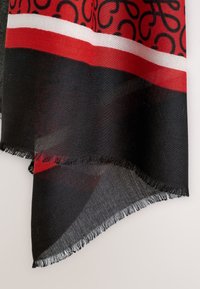 Red and black scarf with a woven pattern, featuring a red band and classic black design. Edges are fringed. Soft, lightweight fabric.