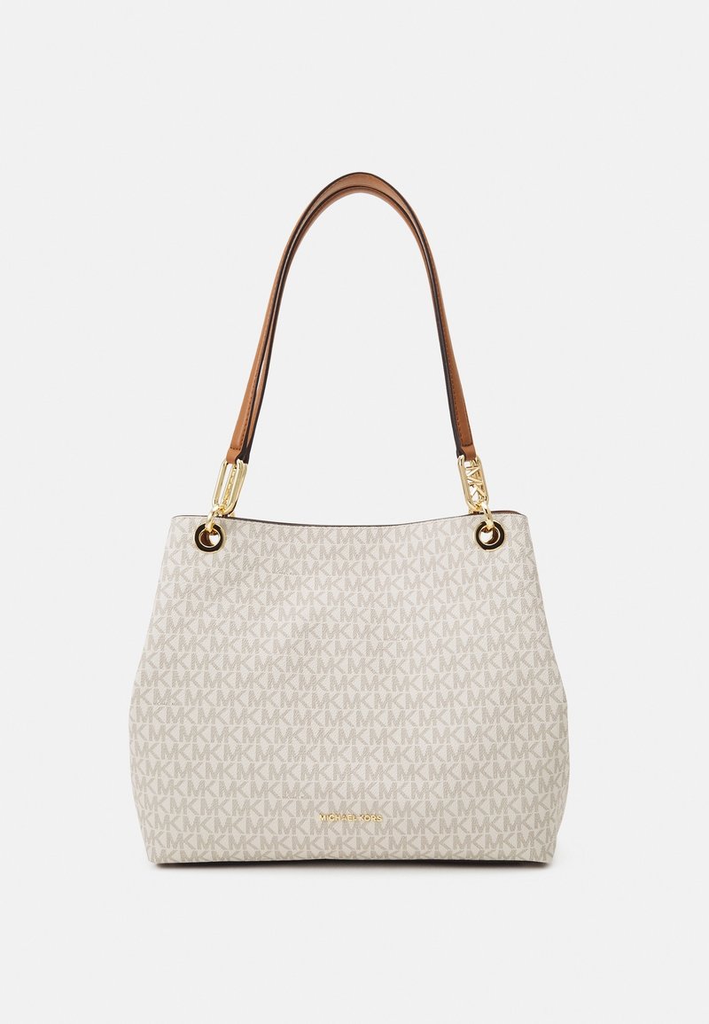 Sac à main beige Michael Kors avec motif répété du logo MK, anses en cuir marron et ferrures dorées sur fond uni.