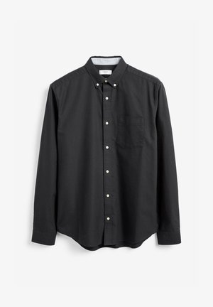 Chemise noire à manches longues, style à boutons, avec une poche poitrine unique, fabriquée en coton lisse, présentant des accents de boutons blancs.