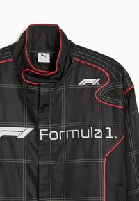 Black racing jacket with red accents, featuring a checkered pattern, high collar, and prominent white "Formula 1" logo on the front.