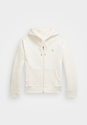 Cream-colored zip-up hoodie made of smooth fabric, featuring a front pocket, drawstring hood, and small logo on the chest.